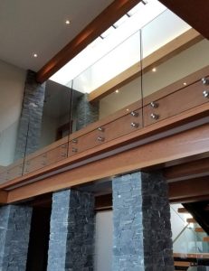 View of a frameless glass deck railings standoff system from below